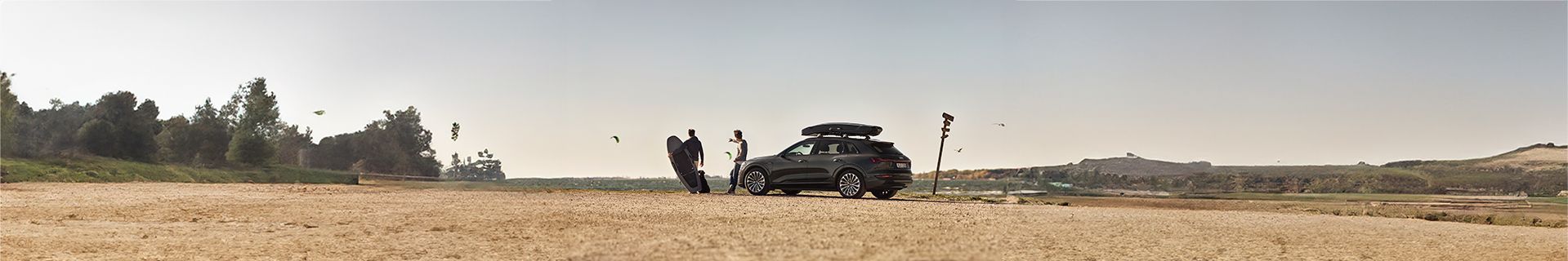 An SUV with a roof rack mounted cargo box