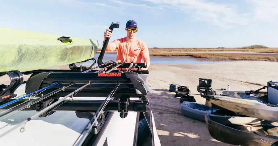 A roof mounted fishing rod carrier being loaded