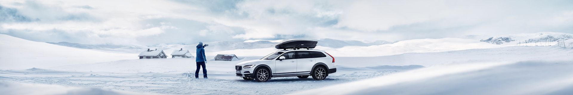 A roof mounted cargo box on a car in the mountains