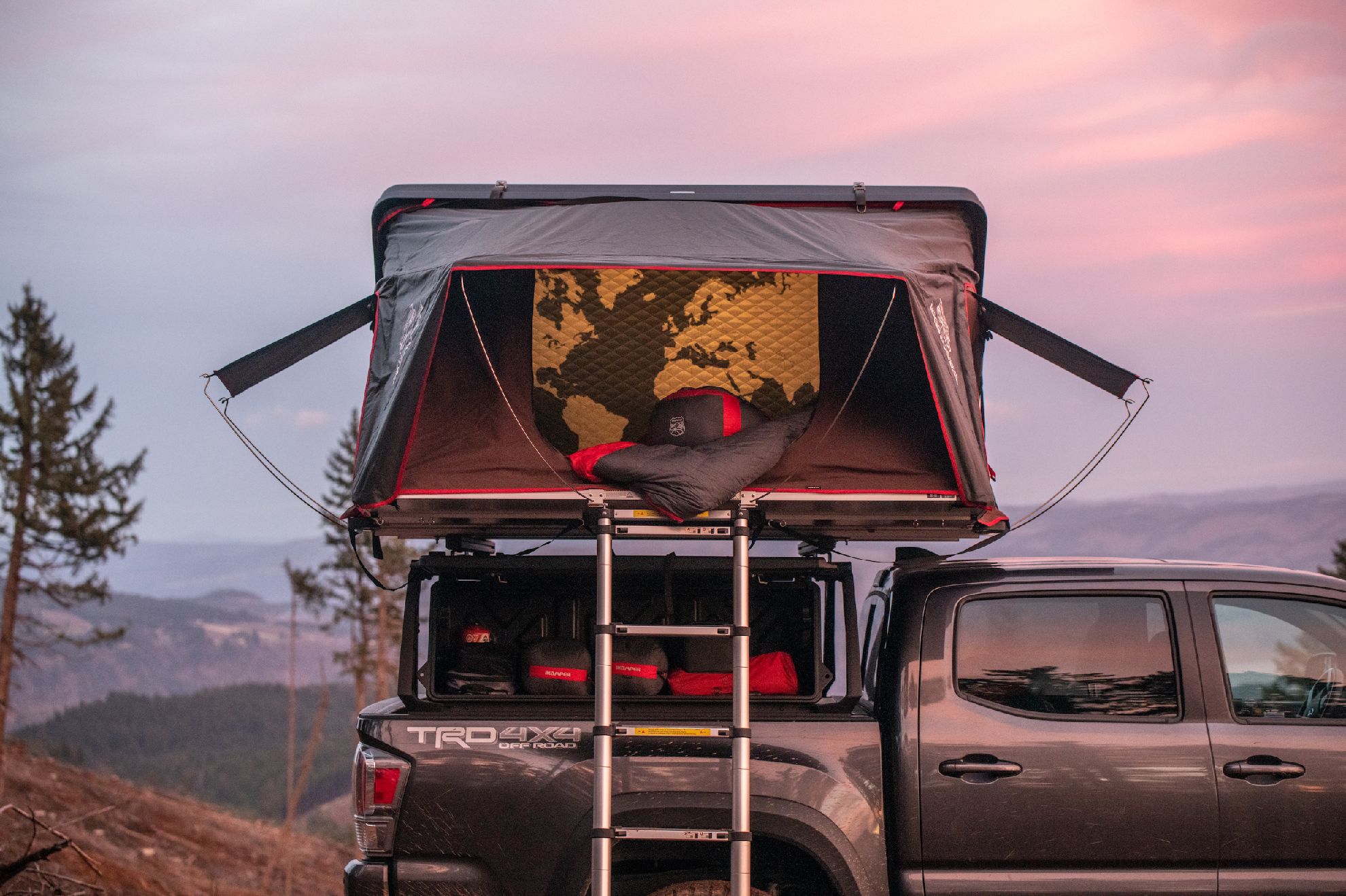 A truck with a hard shell roof top tent