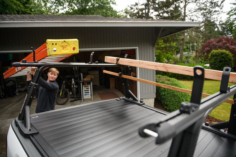 Loading a ladder onto a pickup bed rack mounted to a tonneau cover